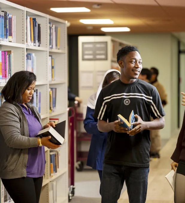 A group of students amongst bookshelves