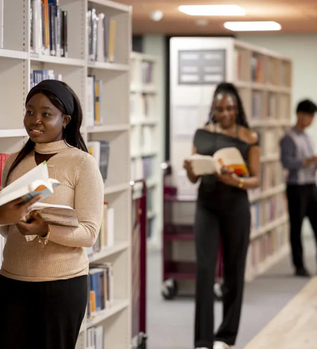A group of students amongst bookshelves