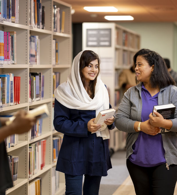 A group of students amongst bookshelves